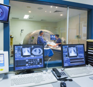 Image of a Doctor, and nurse, putting a patient through a CT Scan